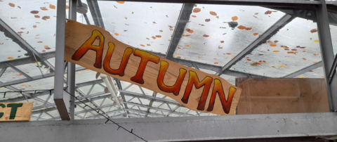 A sign with the word 'Autumn' painted on it
