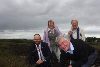 Paul Dennett and Tony Lloyd plant sphagnum watched by Anne Selby and Louise Morrissey on Little Woolden Moss