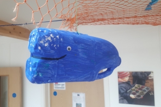 A whale 'Litter Critter' made from a waste milk carton