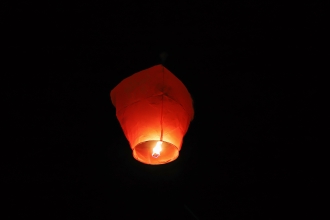 An orange fire lantern glowing in the dark