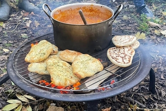 A curry cooking over an open fire