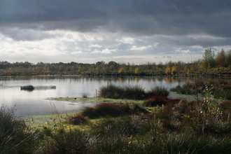A cloudy Little Woolden Moss with a large pool of water.