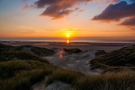 The sun setting in front of the Fylde sand dunes