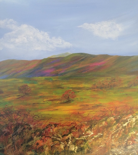 Close up of Carolyn's painting of a hill-top landscape - a blue sky with hills rolling in the background and foliage in the foreground
