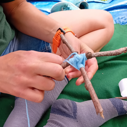 Making a woodland eye decoration from wool and sticks 