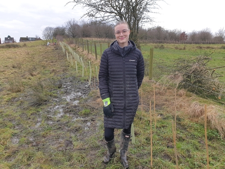 Annabel Winterbottom from Zalaris planting new hedgerow trees