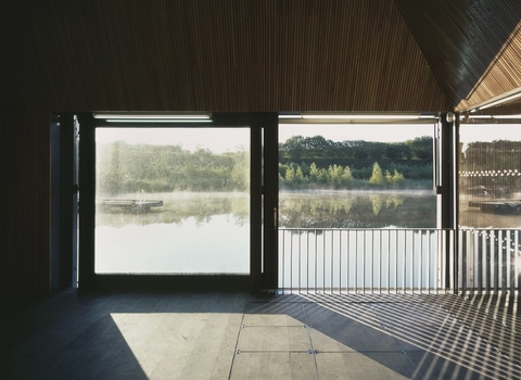 A view of the interior of Meadow Lake Suite looking out a window onto the lake.