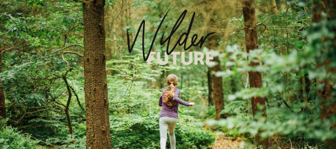 A teenage girl running through woodlands in Yorkshire