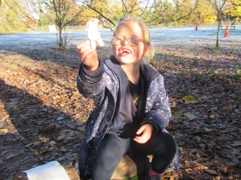 Child smiling with their Christmas craft