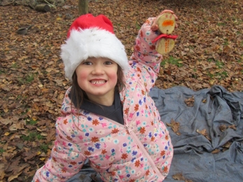 Child smiling with their tree cookie snowman