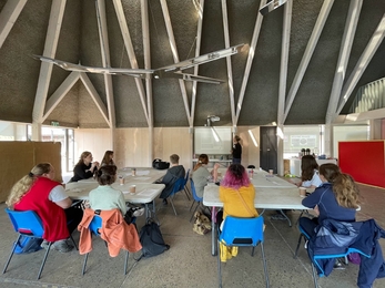 Youth Council sat at tables in the classroom while Emma presents