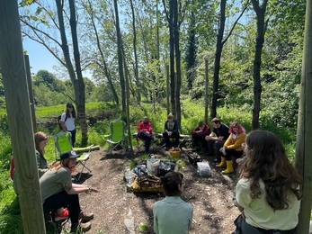 A group shot of the Youth Council round a campfire