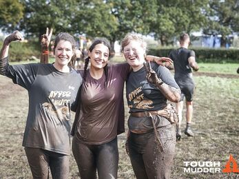 Three very muddy women