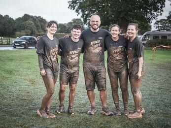 Five very muddy people