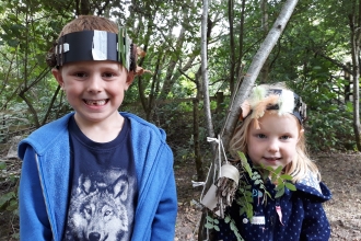 Two children wearing their crafts at Nature Tots at Heysham