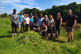 A group of people in the sunshine in a field