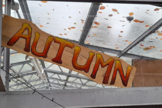 A sign with the word 'Autumn' painted on it