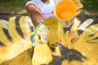 Vanessa painting her yellow mural