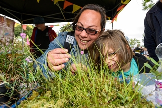 family, engaging with a wildlife activity involving grasses