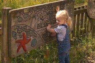 Child playing at the Hive