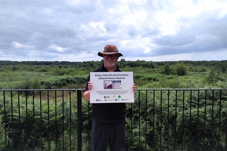 Senior Conservation Officer Martyn Walker with the National Nature Reserve plaque
