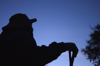 A silhouette of a man at dusk