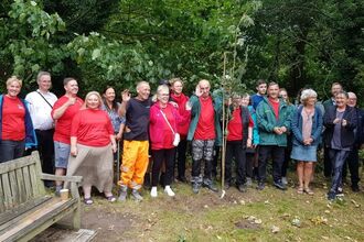A group of people waving and smiling at the camera 