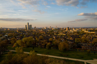 The Manchester Skyline with a park in the foreground by Nick Rodd