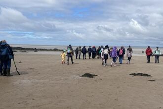 People walking on Morecambe Bay