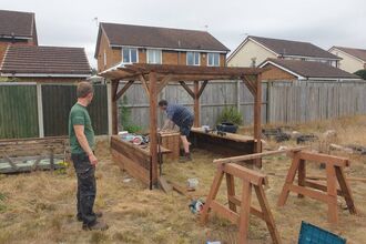 School grounds team installing a mud kitchen 