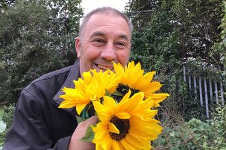 Carl Dutton holding sunflowers