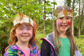 Children wearing nature crowns