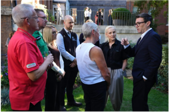 A group of people with PM Andy Burnham