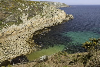 Crystal clear sea and rocky cliffs at Penberth Cove near to Land's End in Cornwall