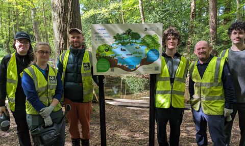A group of people stood with the new interpretation boards