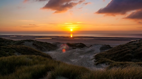 The sun setting in front of the Fylde sand dunes