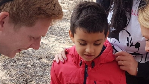 Living Seas North West team talking to a little boy at Seashore Detectives event