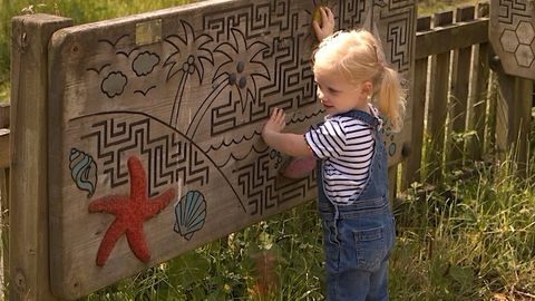 Child playing at the Hive