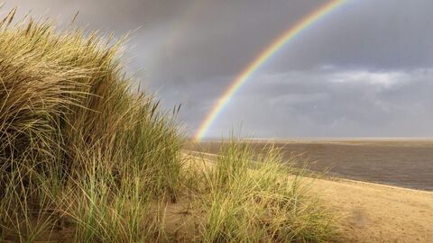 Rainbow over the sea at Fleetwood with the sand dunes in the foreground.