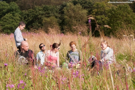 Friends enjoying a picnic in a field during 30 Days Wild