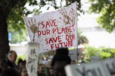 The Myplace team holding up an environmental banner at The Time is Now mass lobby