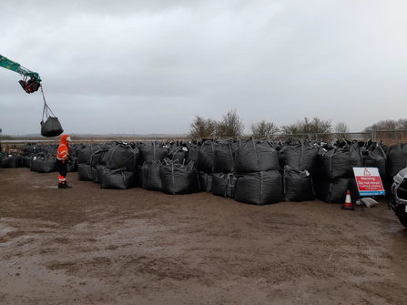 Up to 500 helibags filled with aggregate stockpiled ready to be transported by helicopter to fill in the breach