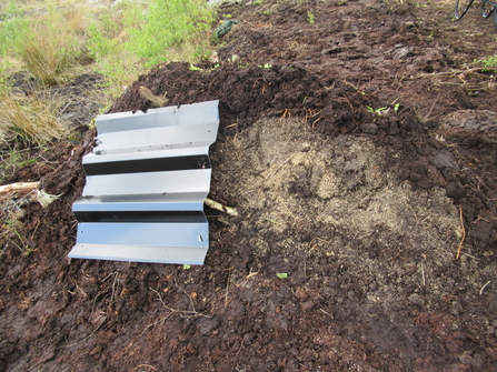 Hibernaculum with metal basking plate and sandy area