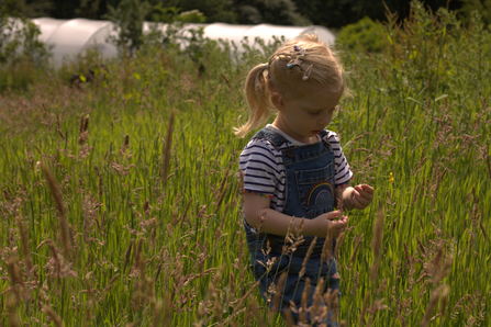 Child playing in the grass