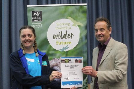 Chloe Desmond accepting the award for most inspirational volunteer of the year on behalf of Neil Pilling at the Supporters Day 2022