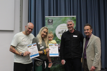 The Cutacre livestock checkers, Rob, Lauren and baby Lyra accepting the award for volunteer group of the year at the Supporters Day 2022