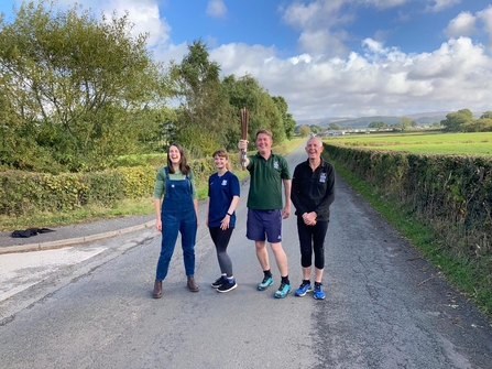 Lancashire Wildlife Trust staff holding the Running out of Time relay baton