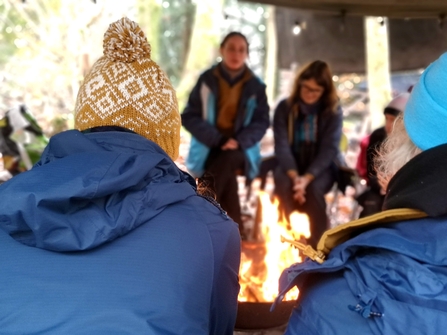 A photo of people around a fire