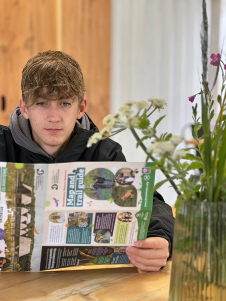 Lewis holding marketing materials