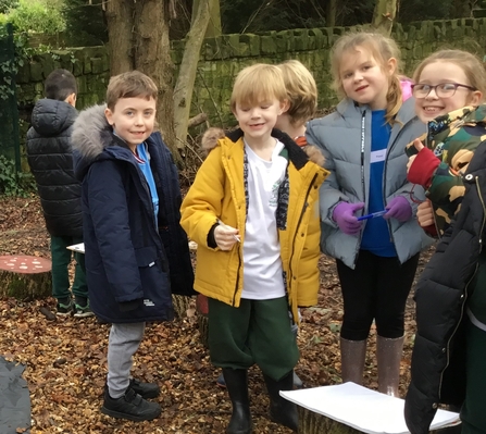 children smiling to camera outdoors